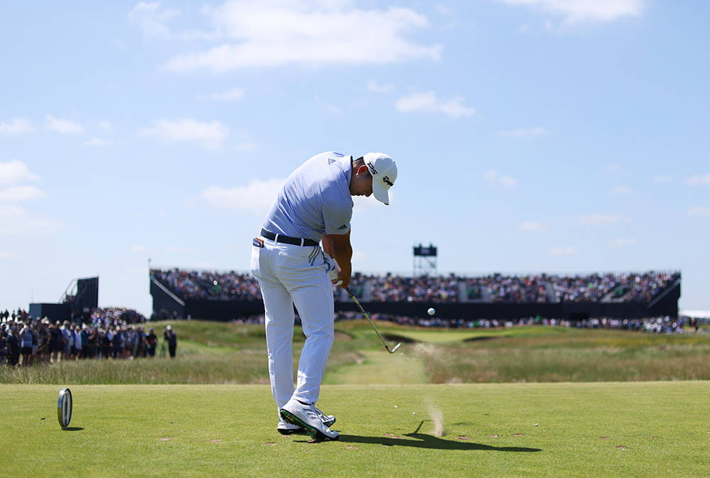 Collin Morikawa playing his tee shot on the 16th